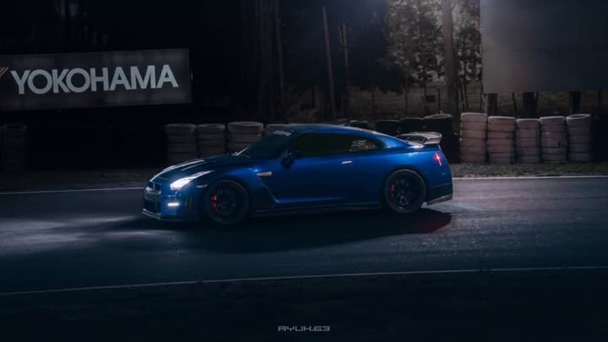 Blue sports car relit for night at the track