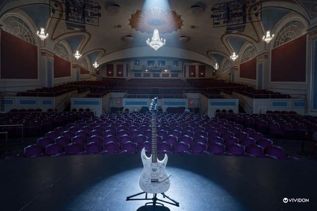 Electric guitar on an empty stage relit with a spotlight