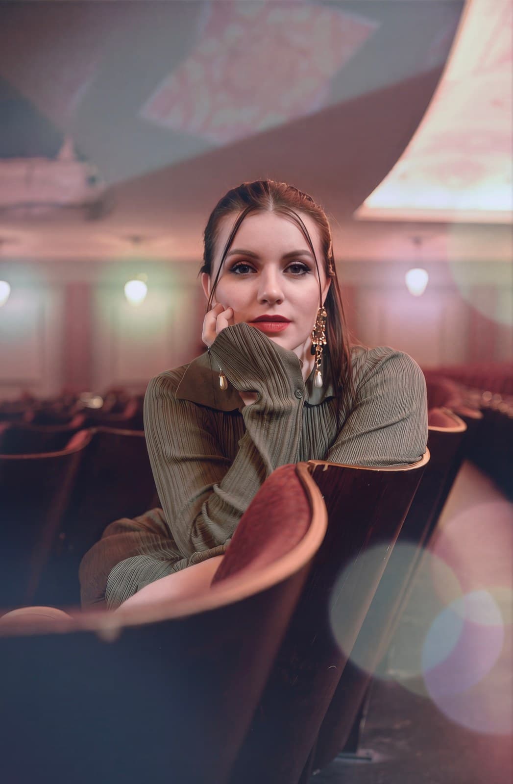 Theater seats relit with warm projector glow
